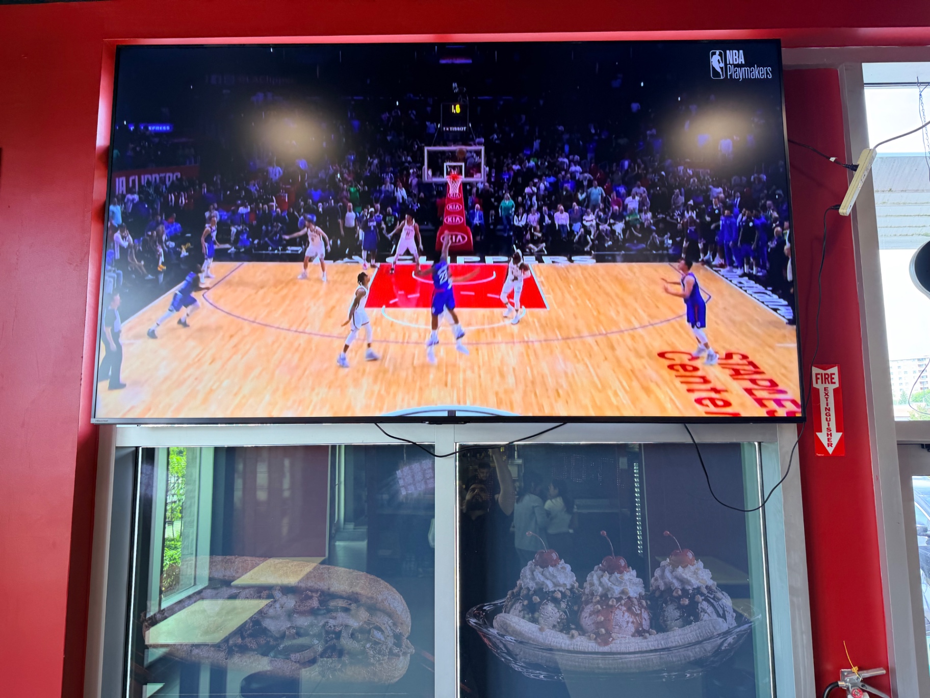 A basketball game playing on the big screen at Hall of Flame